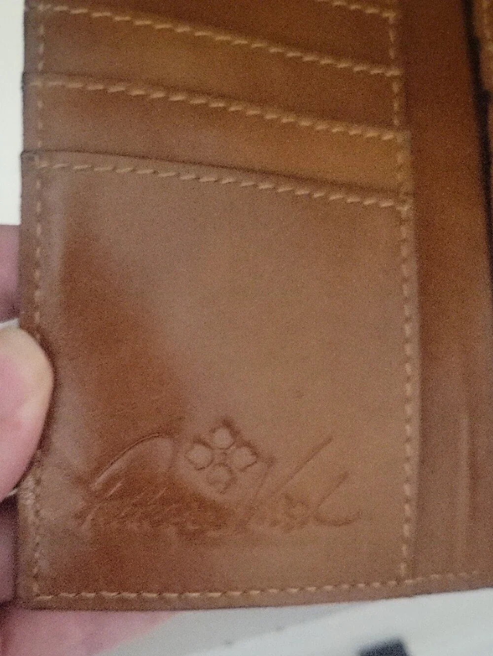 Brown leather Patricia Nash bifold wallet featuring an artistic vintage map back